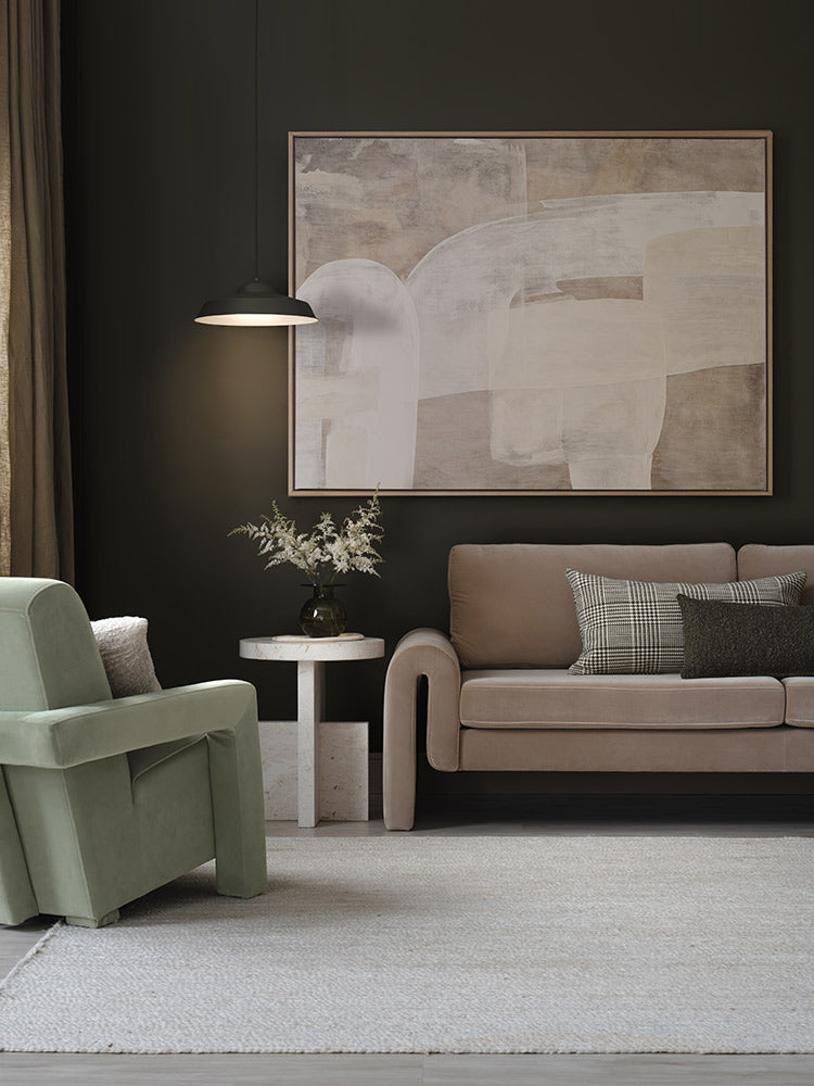 Framed Nostalgic Mood III artwork styled against a dark wall with a taupe sofa, green armchair and other modern neutral decor.