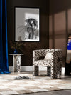Framed Wild Spirit black-and-white portrait art in a modern room with neutral decor, dark cushions, and minimal styling.