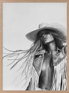 Monochrome photographic portrait artwork featuring a woman wearing a fringe jacket and cowboy hat, expressing bold freedom.
