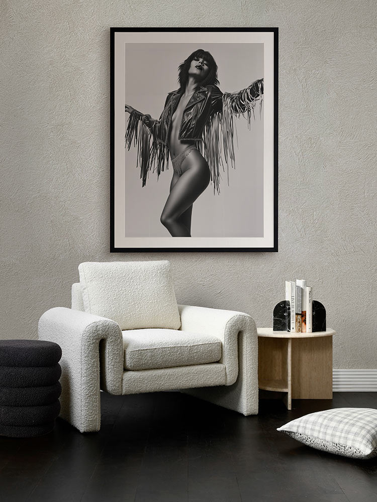 Born to Roam portrait artwork styled above a dark armchair in front of dark green wall, with patterned floor and warm accents.