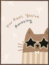 A friendly cat wearing star-shaped sunglasses with the hand-lettered message “fur real, you’re amazing” and small stars, in soft neutral browns, from the Little Tails Collection by Urban Road.