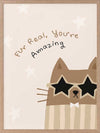 A friendly cat wearing star-shaped sunglasses with the hand-lettered message “fur real, you’re amazing” and small stars, in soft neutral browns, from the Little Tails Collection by Urban Road.