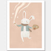 A white bunny holds a paintbrush and palette, sweeping playful painted swirls and star shapes across a pastel pink backdrop, from the Little Tails Collection by Urban Road.