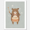 A friendly bear beats a drum with music notes floating around in blue-brown tones, from the Little Tails Collection by Urban Road.
