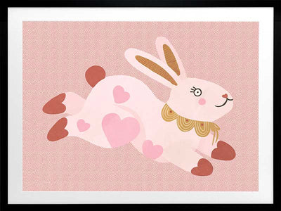 A leaping pink bunny sprinkled with heart patches on a textured blush ground, from the Little Tails collection by Urban Road.