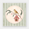 Charming bird perched by a tiny house within a soft green pastel medallion, from the Little Tails Collection by Urban Road.