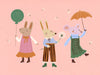 Two rabbits and a mouse parade with a balloon and umbrella across a pink backdrop, from the Little Tails Collection by Urban Road.