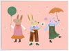 Two rabbits and a mouse parade with a balloon and umbrella across a pink backdrop, from the Little Tails Collection by Urban Road.