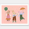 Two rabbits and a mouse parade with a balloon and umbrella across a pink backdrop, from the Little Tails Collection by Urban Road.