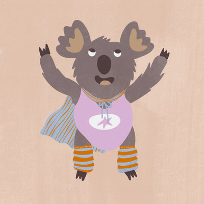 Cheerful koala in a lilac superhero outfit with a cape and striped leggings on warm beige, from the Little Tails Collection by Urban Road.