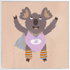Cheerful koala in a lilac superhero outfit with a cape and striped leggings on warm beige, from the Little Tails Collection by Urban Road.