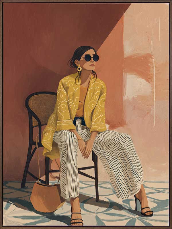 A seated woman in patterned pants and a yellow blouse leans casually against a terracotta wall. From the Lounging Ladies II collection by Urban Road.
