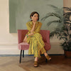 Portrait of a woman in yellow stripes sitting offline in a muted room setting, from the Lounging Ladies II collection by Urban Road.