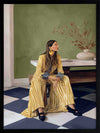 Woman in yellow-striped fashion sits poised against a green wall and patterned flooring in a moment of composed stillness, from the Lounging Ladies II collection by Urban Road.