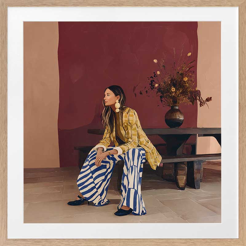 A woman in yellow seated against a moody blue and red backdrop, wearing bold striped pants, from the Lounging Ladies II collection by Urban Road.