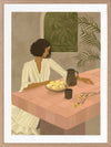 A woman sits beside a plate of lemons on a soft pink tiled table in a quiet interior. From the Lounging Ladies II collection by Urban Road.