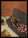 Illustration of a woman relaxing on a neutral sofa with warm orange surroundings and soft plant details, from the Lounging Ladies II collection by Urban Road.