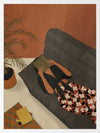 Illustration of a woman relaxing on a neutral sofa with warm orange surroundings and soft plant details, from the Lounging Ladies II collection by Urban Road.