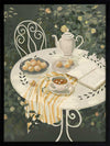 A soft garden scene with a white table set for tea among lush greenery, featuring pastries and striped linens. From the Lounging Ladies II collection by Urban Road.