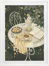 A soft garden scene with a white table set for tea among lush greenery, featuring pastries and striped linens. From the Lounging Ladies II collection by Urban Road.