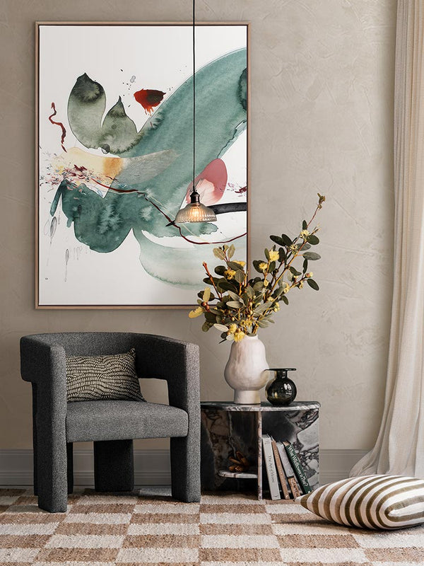 Hidden Cove 3 abstract art print styled with a green armchair with florals, patterned rug, curtains and a striped cushion.