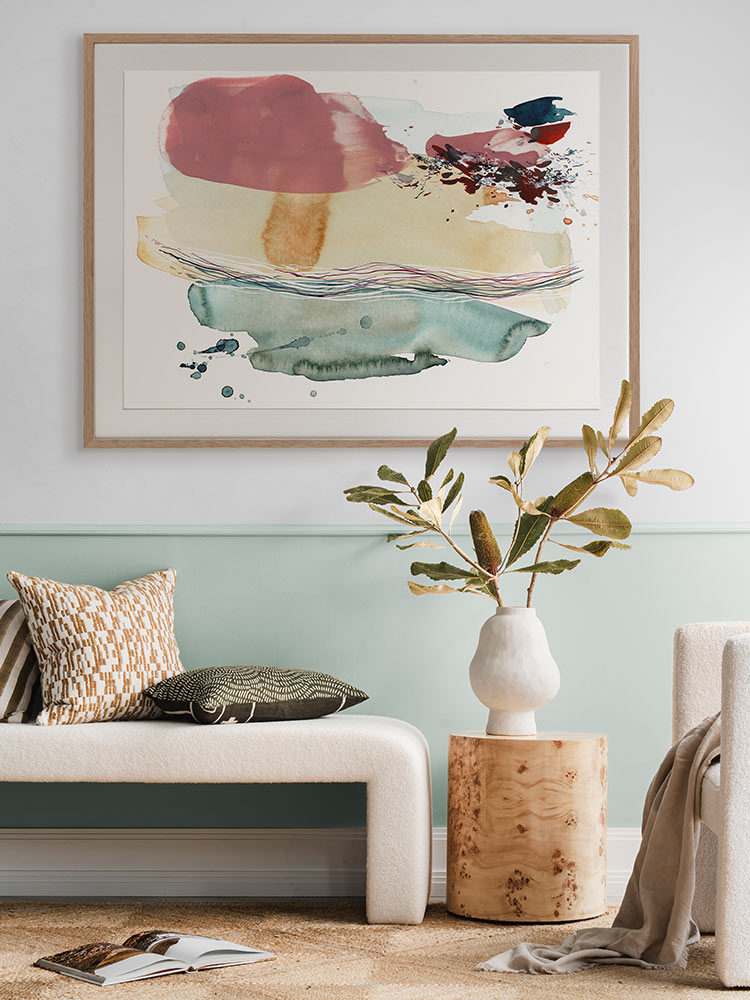 Hidden Cove 6 abstract art print styled in a modern room with neutral decor, rug, warm brown accents, and a green armchair.