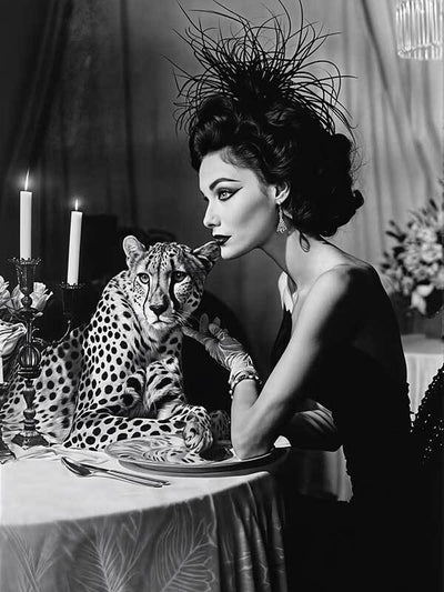 A woman in a chic black dress and feathered hat dines by candlelight with a cheetah in this glamorous, vintage-inspired scene—perfectly captured in the "Feline Couture Canvas Art Print" by Shaynna Blaze x Urban Road.