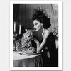 A glamorous woman in an elegant dress and feathered headpiece sits beside a calm cheetah. The Feline Couture Unframed Art Print by Shaynna Blaze x Urban Road brings vintage black-and-white allure to your wall art collection.