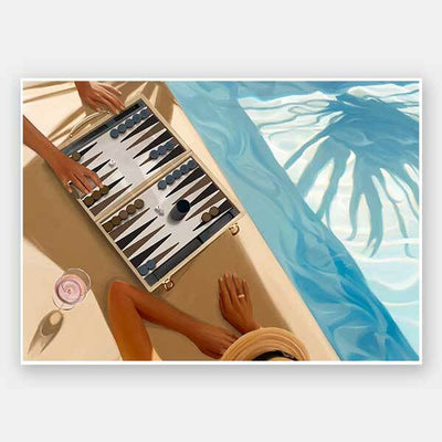 Two people play backgammon by a sunlit pool, drinks and sun hats at hand, with blue water and palm shadows. Relax in style with the Shaynna Blaze x Urban Road Backgammon, Anyone Unframed Art Print.