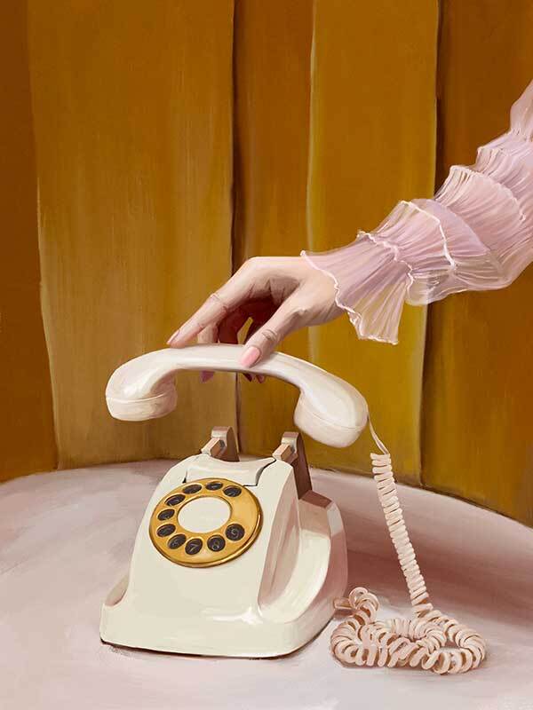 A hand in a sheer, ruffled pink sleeve lifts a vintage cream and yellow rotary phone against gold panels—featured in the Out Of Office Canvas Art Print by Shaynna Blaze x Urban Road.