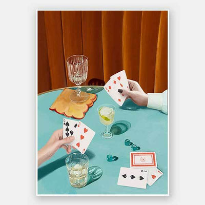 Two hands hold cards over a green table with drinks, dice, and poker chips in this vintage-style Deal Me In Unframed Art Print from the Shaynna Blaze x Urban Road collection, featuring dramatic shadows and an orange curtain.