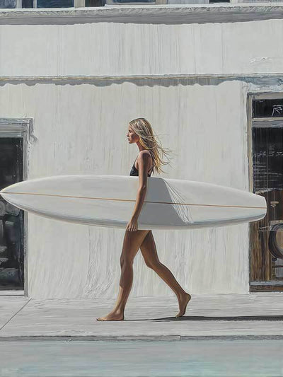A woman in a black swimsuit walks barefoot with a white surfboard under her arm, evoking classic California surf culture in the Not A Care Canvas Art Print by Shaynna Blaze x Urban Road.