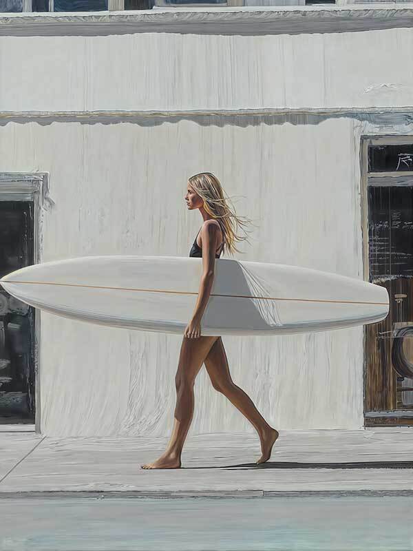 A woman in a black swimsuit walks barefoot with a white surfboard under her arm, evoking classic California surf culture in the Not A Care Canvas Art Print by Shaynna Blaze x Urban Road.