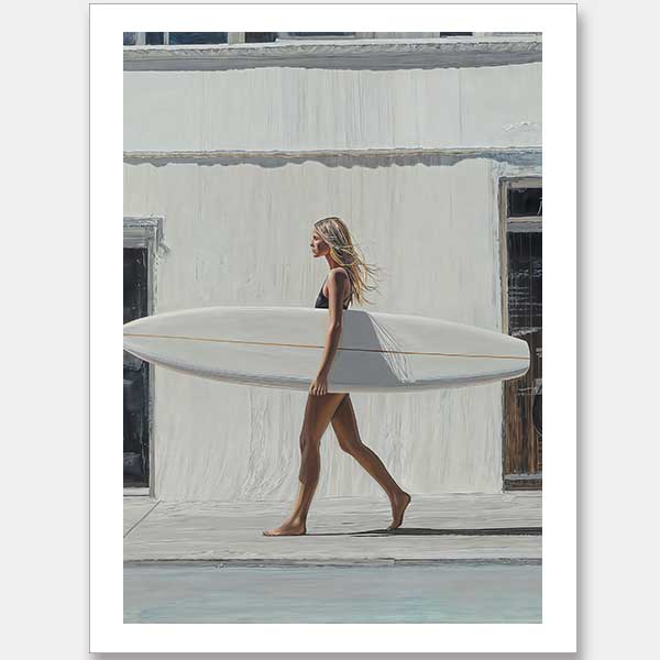 In Not A Care Unframed Art Print by Shaynna Blaze x Urban Road, a woman in a black swimsuit carries a large white surfboard along a sidewalk, evoking California surf culture as she passes a light building.