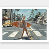 The Stopping Traffic Unframed Art Print by Shaynna Blaze x Urban Road captures California surf culture with a woman in a swimsuit carrying a surfboard across a palm-lined, vintage car-filled street on a sunny day.