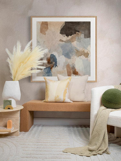 The Desert Rain I art print framed and styled above a textured brown bench, paired with a modern side table, botanical accents, and neutral décor in a sophisticated space.