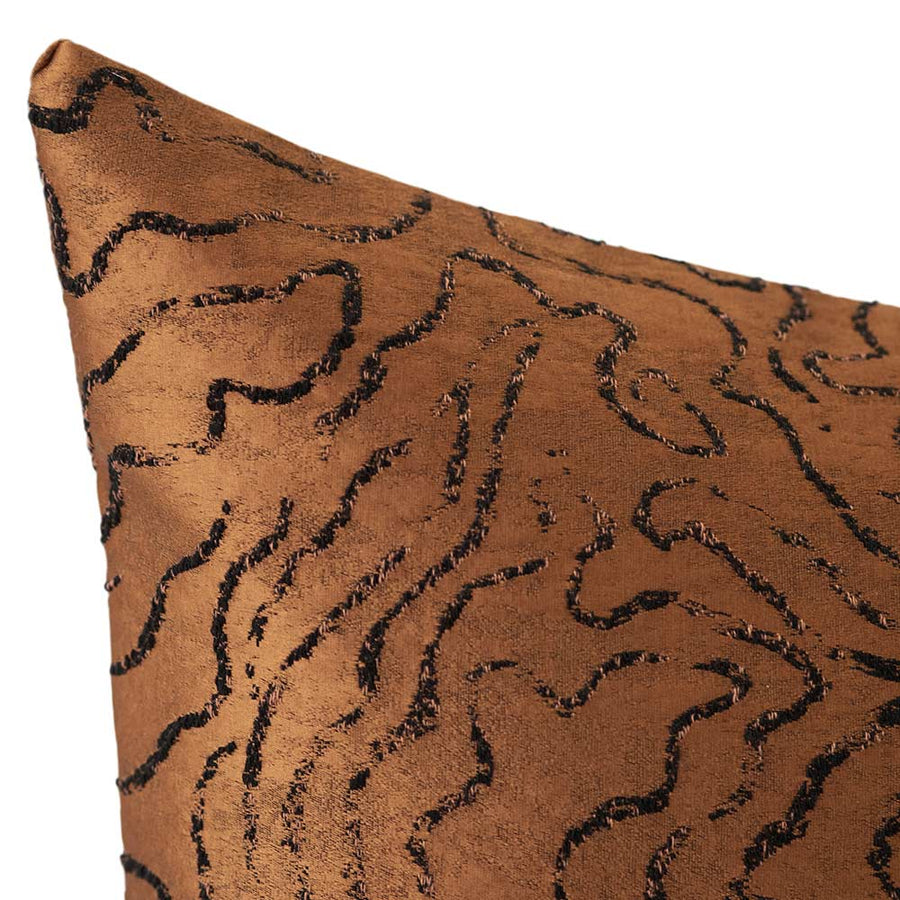 The Emberlane Lumbar Rust Cushion (50x30cm) by Urban Road features a rich brown textured finish with black abstract wavy lines, offering a plush, modern accent ideal for enhancing contemporary interiors.
