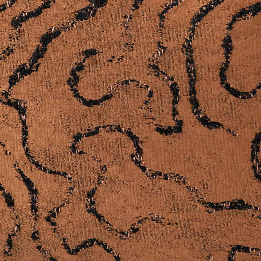 The Emberlane Lumbar Rust Cushion (50x30cm) by Urban Road features a rich brown textured finish with black abstract wavy lines, offering a plush, modern accent ideal for enhancing contemporary interiors.