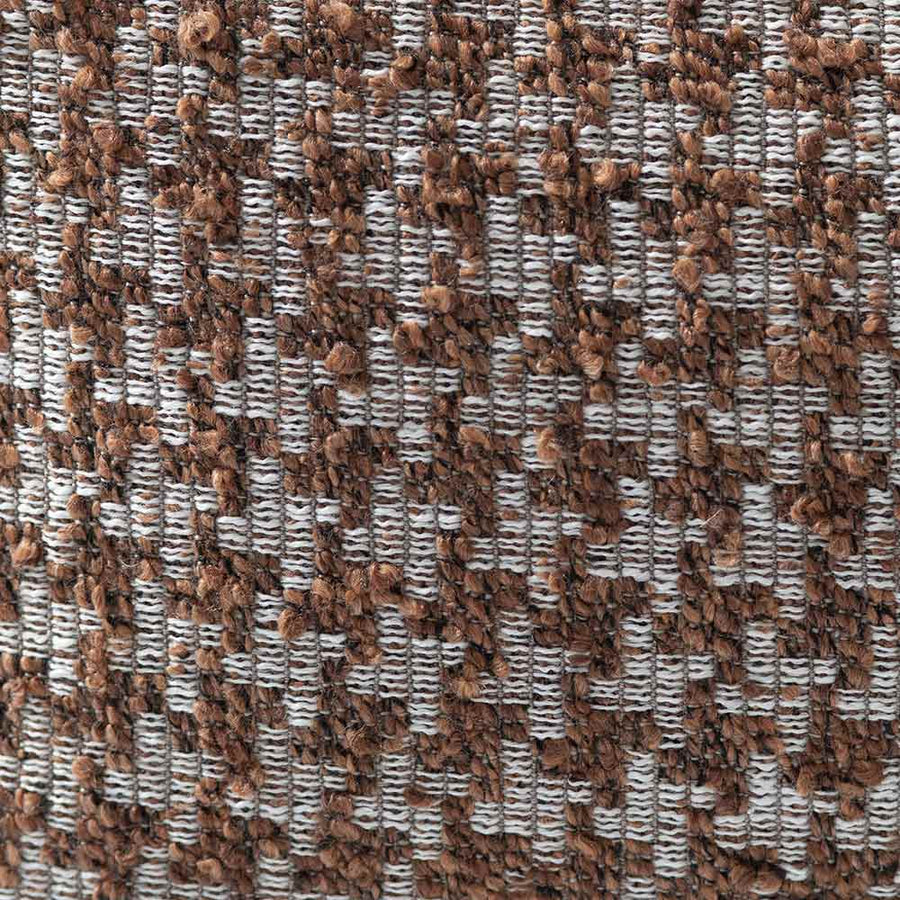 The Hearthstone Rectangle Rust Cushion by Urban Road (80x40cm) features a brown and white houndstooth pattern, pointed corners, and a luxe texture, making it a stylish accent inspired by Darren Palmer’s signature look.