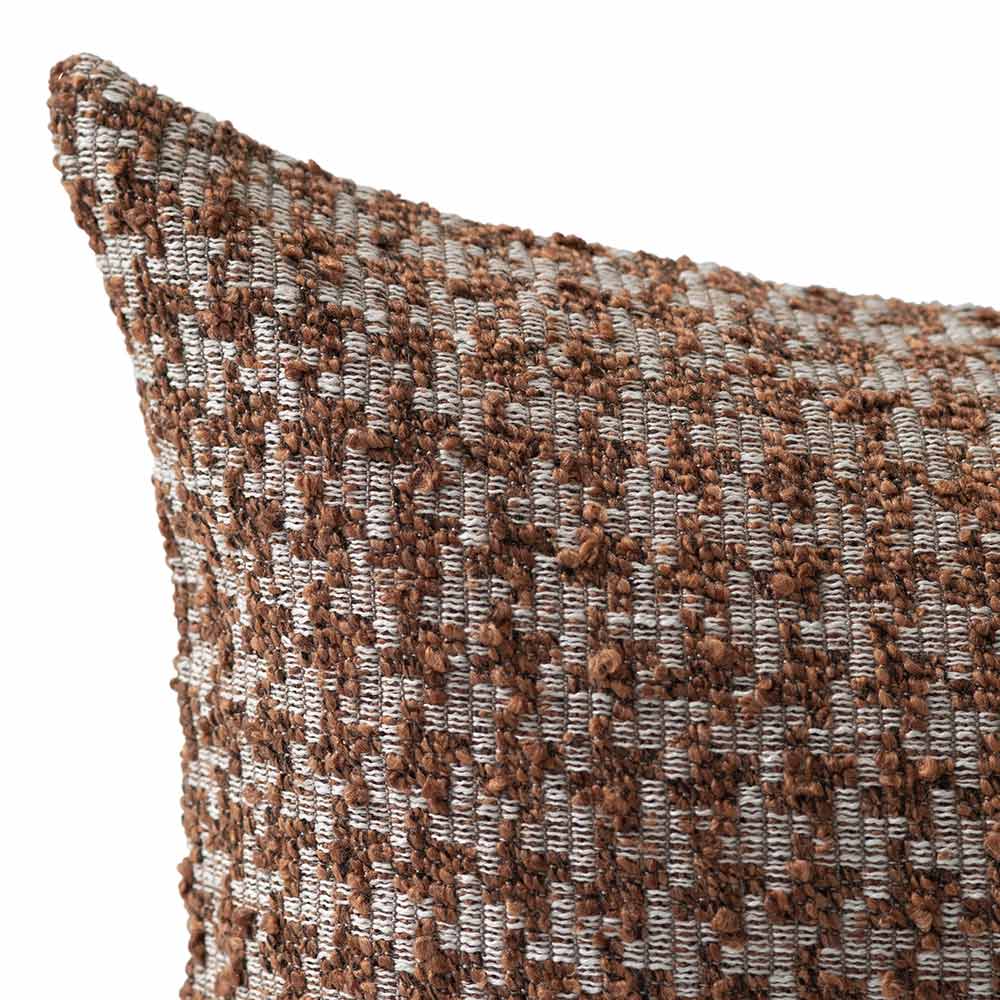 The Hearthstone Rectangle Rust Cushion by Urban Road (80x40cm) features a brown and white houndstooth pattern, pointed corners, and a luxe texture, making it a stylish accent inspired by Darren Palmer’s signature look.
