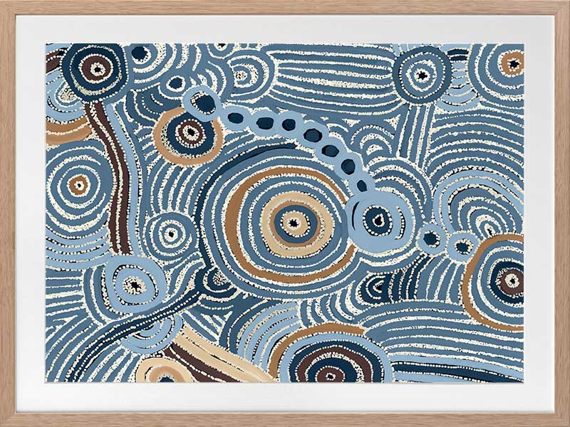 Concentric circle motifs and flowing white dot patterns in navy blue, sky blue, and ochre against a textured pale blue background. From the Maria Watson-Trudgett collection with Urban Road.