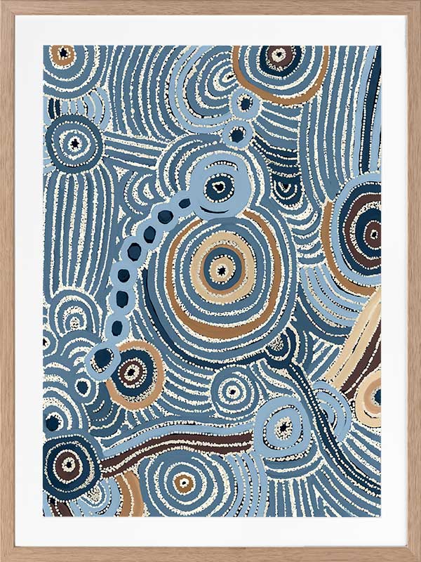 Concentric circle motifs and flowing white dot patterns in navy blue, sky blue, and ochre against a textured pale blue background. From the Maria Watson-Trudgett collection with Urban Road.