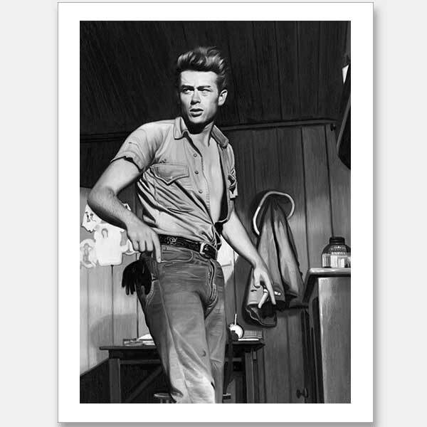 A black-and-white James Dean Mono Unframed Art Print by Urban Road is displayed in a wood-paneled room, featuring a young man in jeans and an open shirt. A jacket hangs on the wall and other Urban Road products are visible on the desk behind him.