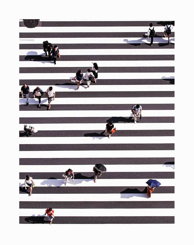 The Pedestrian Unframed Art Print by Urban Road captures an aerial view of people with bags or umbrellas crossing a bold zebra crossing, their shadows visible on the urban pavement.
