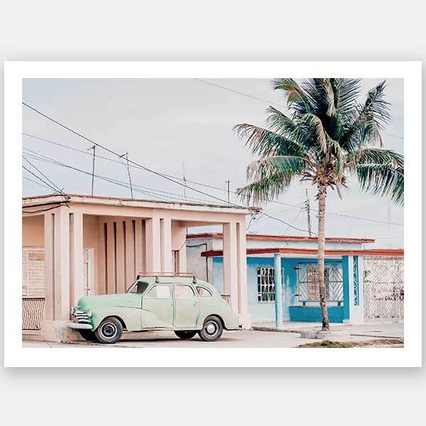 The Urban Road "Pastel La Palma" unframed art print captures a mint green beach wagon by a blue-trimmed house and palm tree under sunny skies, blending vintage charm with pastel tones for a stunning photographic wall piece.