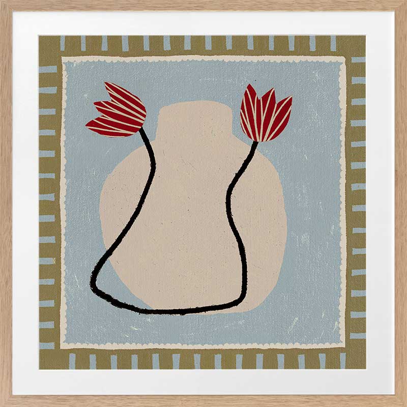 Light and airy composition of a cream vase with red blooms on a pale blue backdrop with striped green borders, from the Shatha collection with Urban Road.