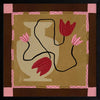 Abstract floral composition with red blooms on black curving stems over a camel and brown patchwork base, framed in soft pink, from the Shatha collection with Urban Road.