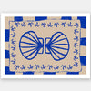 Symmetrical blue shell motif with palm-like flourishes, framed by a blue and cream checkered border on a neutral base, from the Shatha collection with Urban Road.