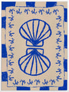 Symmetrical blue shell motif with palm-like flourishes, framed by a blue and cream checkered border on a neutral base, from the Shatha collection with Urban Road.