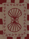 Mirrored burgundy seashell design with curved botanical accents, set on a brown background with a bold burgundy striped border, from the Shatha collection with Urban Road.